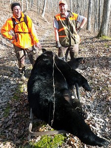 Brett and Shawn take a break from hauling the bear out of the woods.